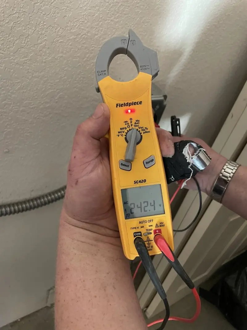 Voltage testing with clamp meter during Whole House Surge Protector in North Londonderry